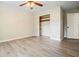Bedroom featuring wood-look flooring, a ceiling fan, an adjacent closet, and neutral walls at 588 Benson Hurst Sw Dr, Mableton, GA 30126