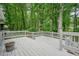 White wooden deck surrounded by green trees and foilage at 588 Benson Hurst Sw Dr, Mableton, GA 30126