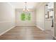 Bright dining room with hardwood floors and a modern chandelier near the kitchen area at 588 Benson Hurst Sw Dr, Mableton, GA 30126