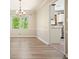 Charming dining room with hardwood floors and a modern chandelier lighting at 588 Benson Hurst Sw Dr, Mableton, GA 30126