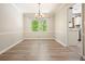 Bright dining room with hardwood floors, white trim, and a stylish chandelier at 588 Benson Hurst Sw Dr, Mableton, GA 30126
