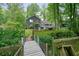 Backyard view with a deck, fenced yard, and mature trees creating a private outdoor retreat at 588 Benson Hurst Sw Dr, Mableton, GA 30126