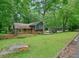 Charming home with a lush green yard, beautiful trees and stone and brick details at 588 Benson Hurst Sw Dr, Mableton, GA 30126