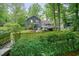 Charming home exterior with a deck, fenced yard, and lush greenery creating a private outdoor space at 588 Benson Hurst Sw Dr, Mableton, GA 30126