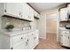 Kitchen with white cabinetry, tiled backsplash, stainless appliances, and wood-trimmed countertops at 588 Benson Hurst Sw Dr, Mableton, GA 30126