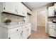 Bright kitchen features white cabinets, tile backsplash, and spacious countertops at 588 Benson Hurst Sw Dr, Mableton, GA 30126