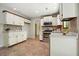 Eat-in kitchen features white cabinets, stainless steel appliances, and tile flooring at 588 Benson Hurst Sw Dr, Mableton, GA 30126