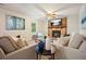 Cozy living room features a stone fireplace, neutral colors, and comfortable seating at 588 Benson Hurst Sw Dr, Mableton, GA 30126