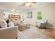 Spacious living room with ample seating, natural light, and neutral color palette at 588 Benson Hurst Sw Dr, Mableton, GA 30126