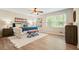 Cozy main bedroom featuring a ceiling fan, rug, and two ottomans by the bed at 588 Benson Hurst Sw Dr, Mableton, GA 30126
