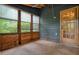 The wood-constructed porch features lots of windows and an exterior door to the outside at 588 Benson Hurst Sw Dr, Mableton, GA 30126