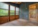 This screened in porch features wood flooring and painted wood paneling and windows at 588 Benson Hurst Sw Dr, Mableton, GA 30126