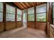 The porch with wood construction features walls of windows overlooking the outdoors at 588 Benson Hurst Sw Dr, Mableton, GA 30126