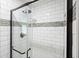 Close-up view of the shower with white subway tile and updated fixtures and glass door at 588 Benson Hurst Sw Dr, Mableton, GA 30126