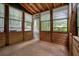 A bright sunroom featuring wood panels and many windows with a ceiling fan at 588 Benson Hurst Sw Dr, Mableton, GA 30126