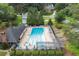 Aerial view of a community pool with lounge chairs and umbrellas surrounded by lush greenery at 2630 Weddington Ne Pl, Marietta, GA 30068