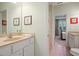 Bathroom features dual sinks, tile floors, and access to a bedroom with plantation shutters at 2630 Weddington Ne Pl, Marietta, GA 30068