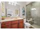 Bathroom features a glass enclosed tiled shower, vanity with mirror, and a toilet at 2630 Weddington Ne Pl, Marietta, GA 30068