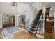Elegant foyer with hardwood floors, a staircase with carpet runner, and a view into the dining room at 2630 Weddington Ne Pl, Marietta, GA 30068