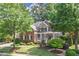 Charming brick and stone home featuring a welcoming front porch and well-manicured lawn at 2630 Weddington Ne Pl, Marietta, GA 30068