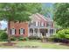 Charming two-story brick home featuring a welcoming front porch and beautifully landscaped front yard at 2630 Weddington Ne Pl, Marietta, GA 30068