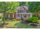 Beautiful brick and stone home with a welcoming front porch and professionally landscaped yard at 2630 Weddington Ne Pl, Marietta, GA 30068