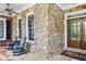 Inviting front porch with stone details and rocking chairs, a perfect spot to relax at 2630 Weddington Ne Pl, Marietta, GA 30068
