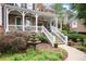 Inviting front porch with white railings and steps, complemented by a tiered fountain at 2630 Weddington Ne Pl, Marietta, GA 30068