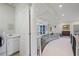 Bright hallway features a coffered ceiling, iron railing, and access to the laundry room at 2630 Weddington Ne Pl, Marietta, GA 30068