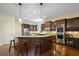 Gourmet kitchen with a large island, stainless steel appliances, and dark wood cabinetry at 2630 Weddington Ne Pl, Marietta, GA 30068