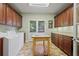 Bright laundry room featuring ample cabinetry, granite countertops and an island for folding at 2630 Weddington Ne Pl, Marietta, GA 30068