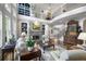 Elegant living room with a stone fireplace, tall windows, and a view of the upper-level balcony at 2630 Weddington Ne Pl, Marietta, GA 30068