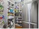 Well-organized pantry with stainless steel fridge and shelving for ample storage of food and kitchen items at 2630 Weddington Ne Pl, Marietta, GA 30068