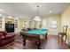 Recreation room features a pool table, built in shelves, and wood flooring at 2630 Weddington Ne Pl, Marietta, GA 30068