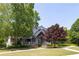 Community clubhouse boasts lush landscaping, a covered entry, and a welcoming front porch at 313 Willow Cv, Canton, GA 30114