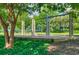 Playground featuring swings and slides surrounded by lush landscaping, providing a recreational area for children at 313 Willow Cv, Canton, GA 30114