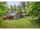 A home featuring a verdant backyard with lush greenery and landscaping at 4507 Reva Way, Marietta, GA 30066