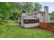 Lush green backyard with a charming screened-in porch and plenty of space for outdoor enjoyment at 4507 Reva Way, Marietta, GA 30066