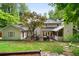 Expansive backyard featuring a wooden deck, lush greenery, mature trees, and stone pathway at 4507 Reva Way, Marietta, GA 30066
