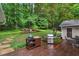Inviting backyard with a wooden deck, outdoor grill, seating area, and serene wooded backdrop at 4507 Reva Way, Marietta, GA 30066