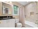 Bathroom with tub and shower combo, natural light, and tiled walls at 4507 Reva Way, Marietta, GA 30066