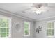 A cozy bedroom featuring a ceiling fan, and two windows, enhancing the bright and airy feel at 4507 Reva Way, Marietta, GA 30066