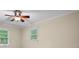 Bright bedroom featuring a ceiling fan and two windows providing ample natural light at 4507 Reva Way, Marietta, GA 30066