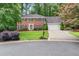 Charming two-story brick home featuring a manicured lawn, mature trees, and a two-car garage at 4507 Reva Way, Marietta, GA 30066