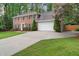 Spacious brick home with a long driveway, a two-car garage, and neatly trimmed shrubs at 4507 Reva Way, Marietta, GA 30066