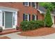 Charming brick home with a manicured front garden, a well-lit entrance, and mature greenery at 4507 Reva Way, Marietta, GA 30066