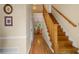 Inviting home hallway with wood floors and stairs that offers a view of the dining room in the background at 4507 Reva Way, Marietta, GA 30066