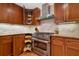 Gourmet kitchen with wood cabinets, pull-out pantry, stainless steel appliances, granite countertops, and tiled backsplash at 4507 Reva Way, Marietta, GA 30066