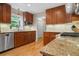 Well-equipped kitchen featuring wood cabinets, granite countertops, stainless steel appliances, and tiled backsplash at 4507 Reva Way, Marietta, GA 30066