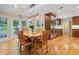 Eat-in kitchen with stainless steel appliances, wood cabinets, hardwood floors, and glass doors to the backyard at 4507 Reva Way, Marietta, GA 30066